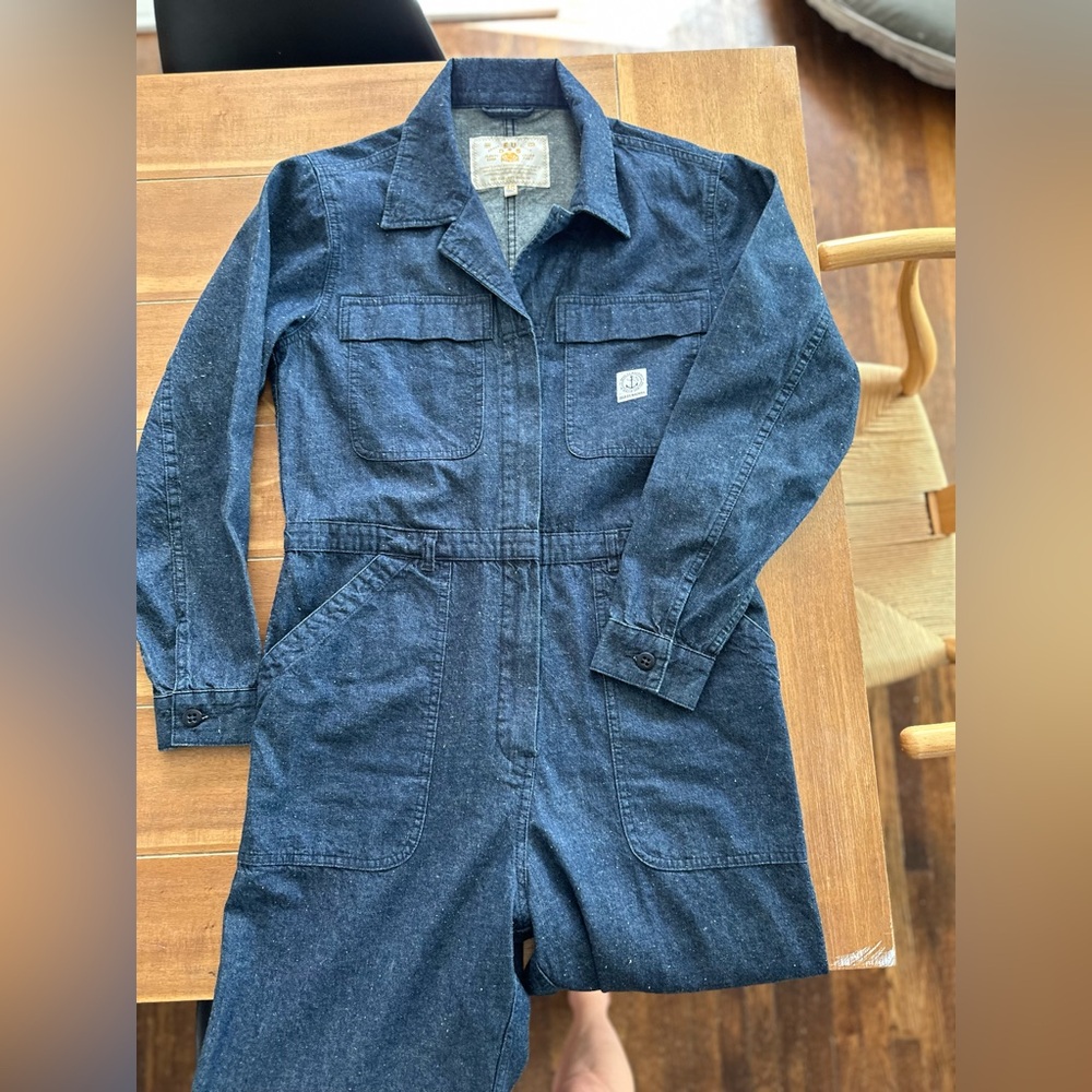 Blue utility jumpsuit. Long sleeve. Sips up the front. Size is M/L.